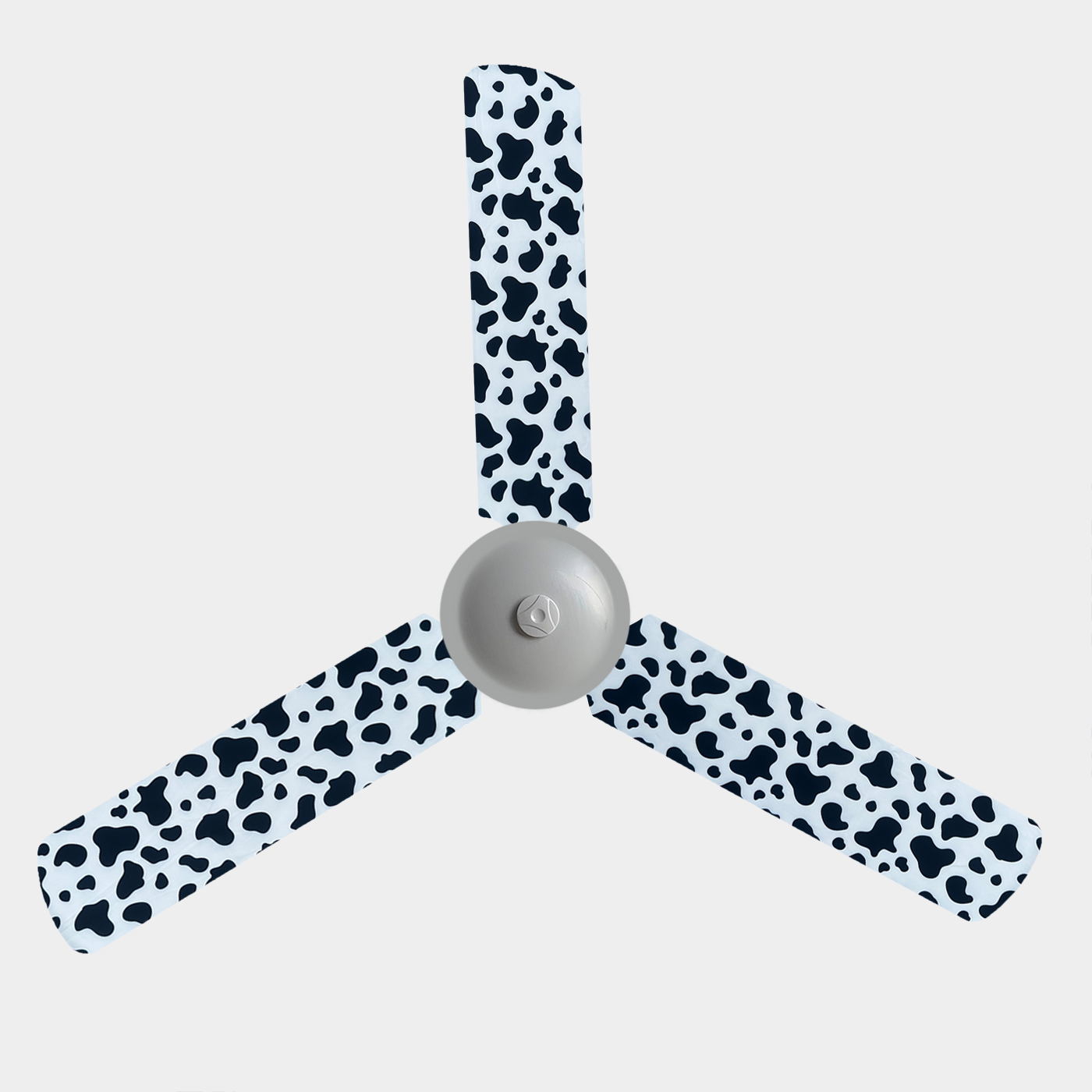 Cow print fabric fan blade covers on a 3 blade ceiling fan