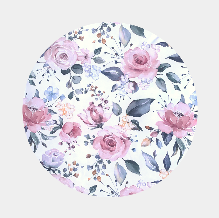 Patterns of large pink roses and green leaves and on a white background