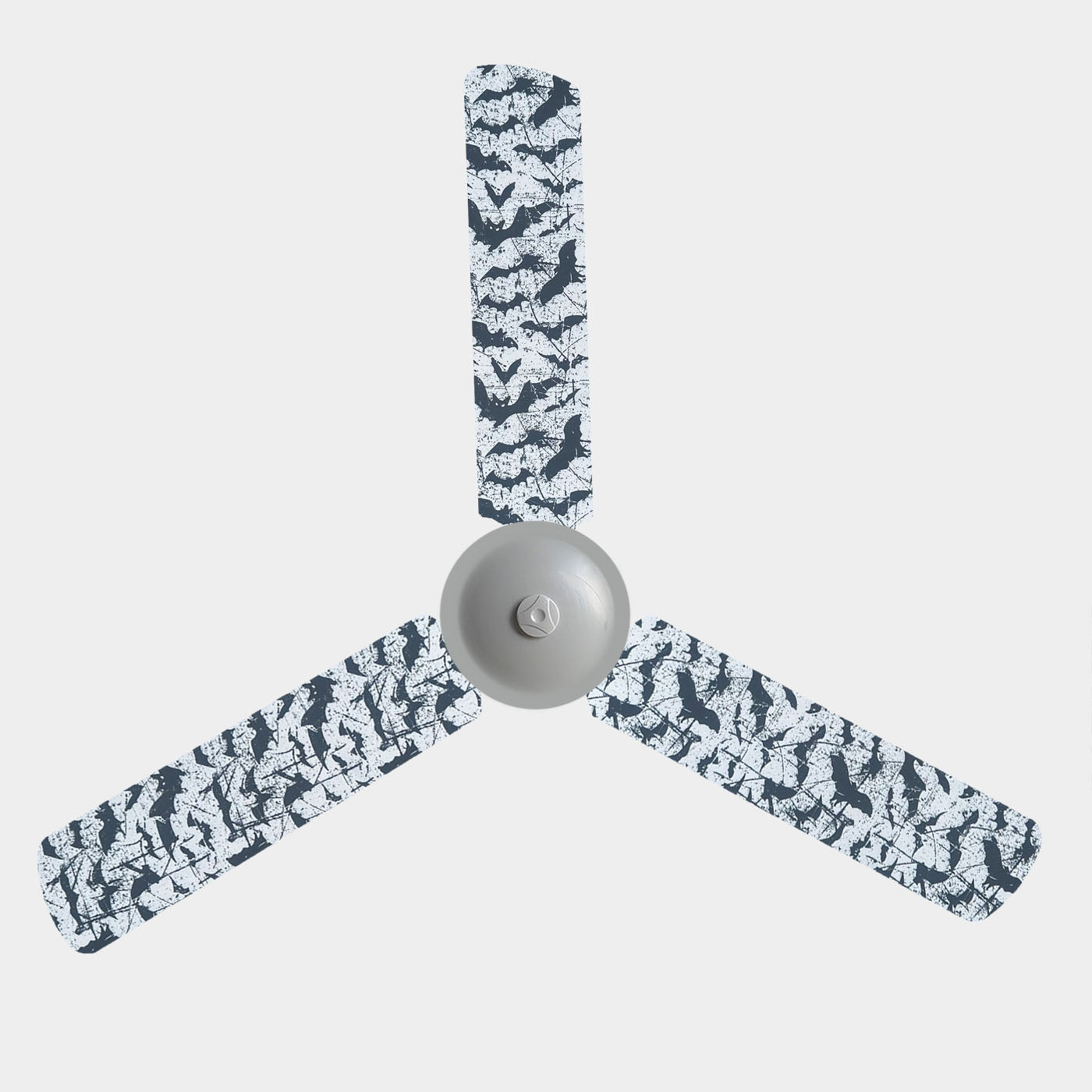 A 3 blade ceiling fan with fabric covers with the design of black bats on a white background