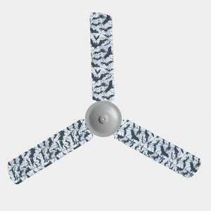 A 3 blade ceiling fan with fabric covers with the design of black bats on a white background