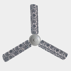 3 blade ceiling fan with fabric covers with a peach/pale pink base and black floral lace design