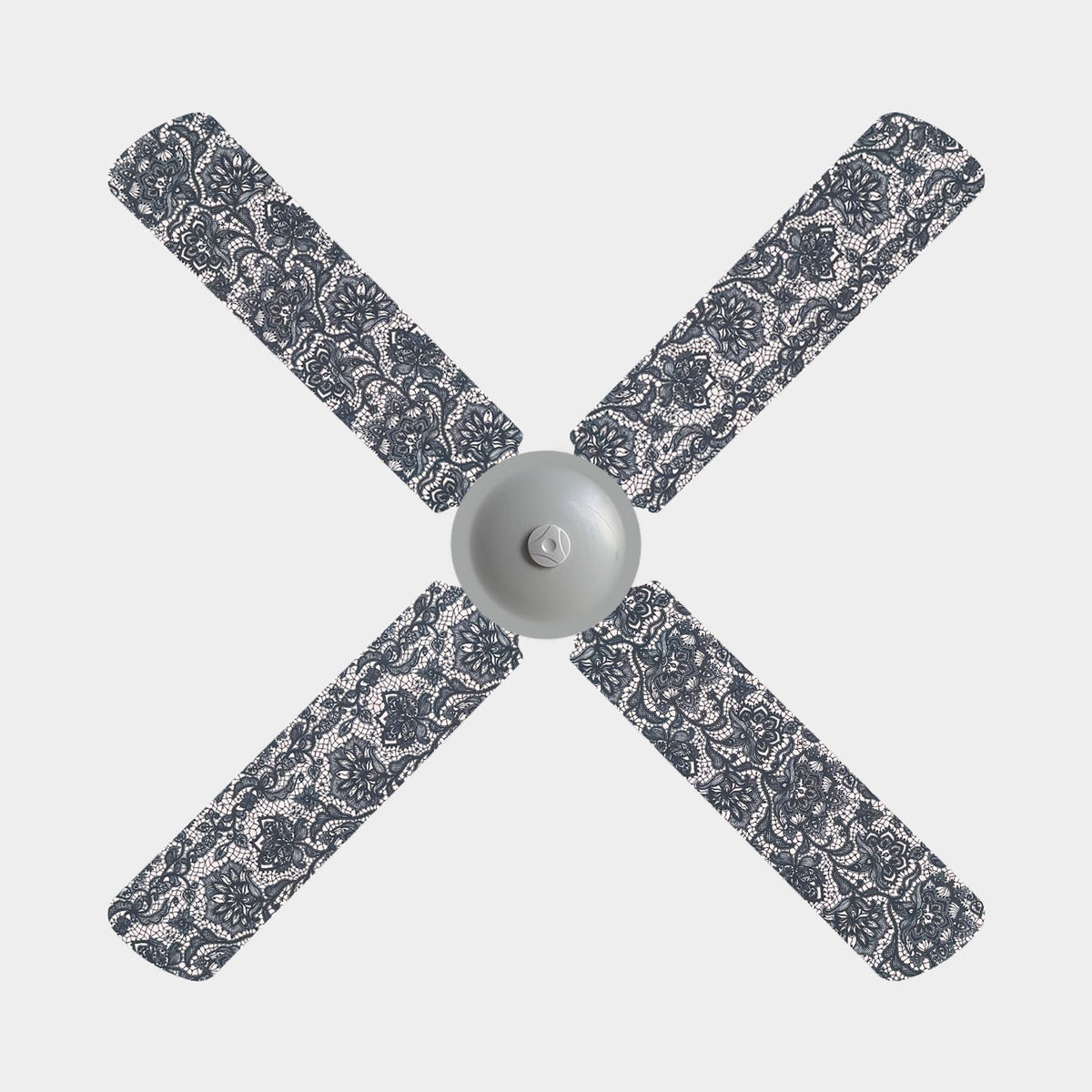 Peach/pink base fabric ceiling fan covers with a floral black lace design on a 4 blade ceiling fan