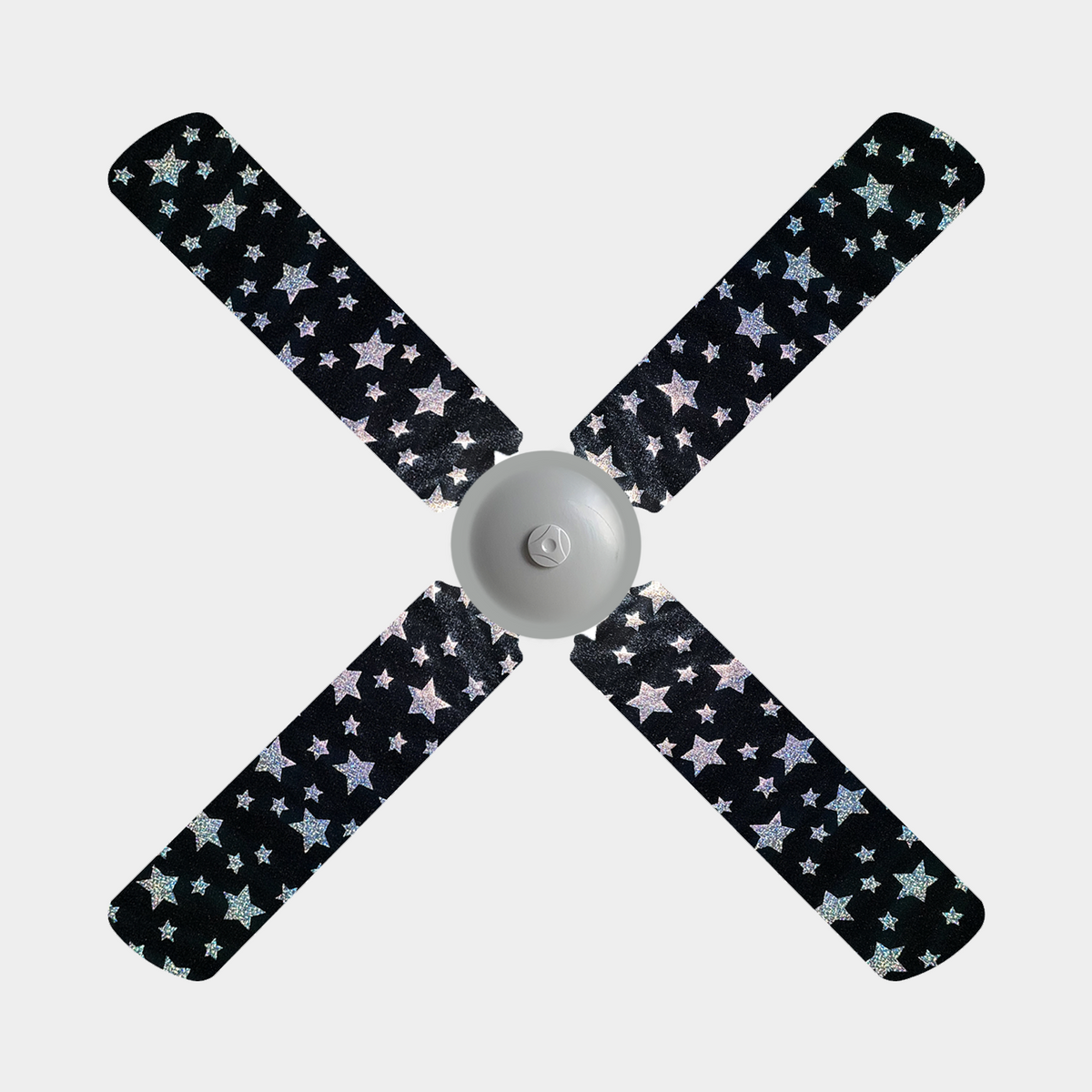 Black ceiling fan blade covers with holographic stars on them on a 4 blade ceiling fan