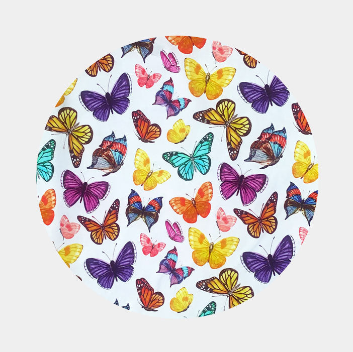 Pattern of purple, yellow, red, pink, and blue butterflies on white background