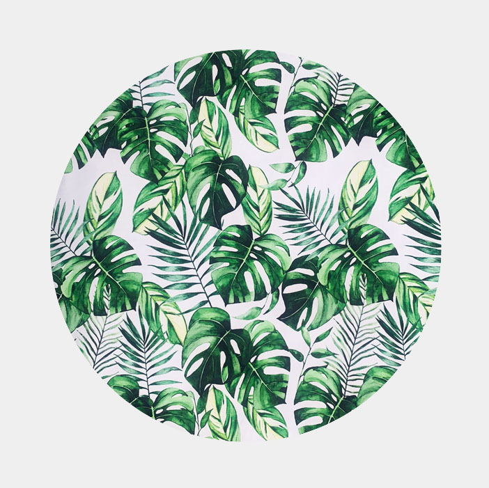 Green monstera leaves and green fern fabric print on white background