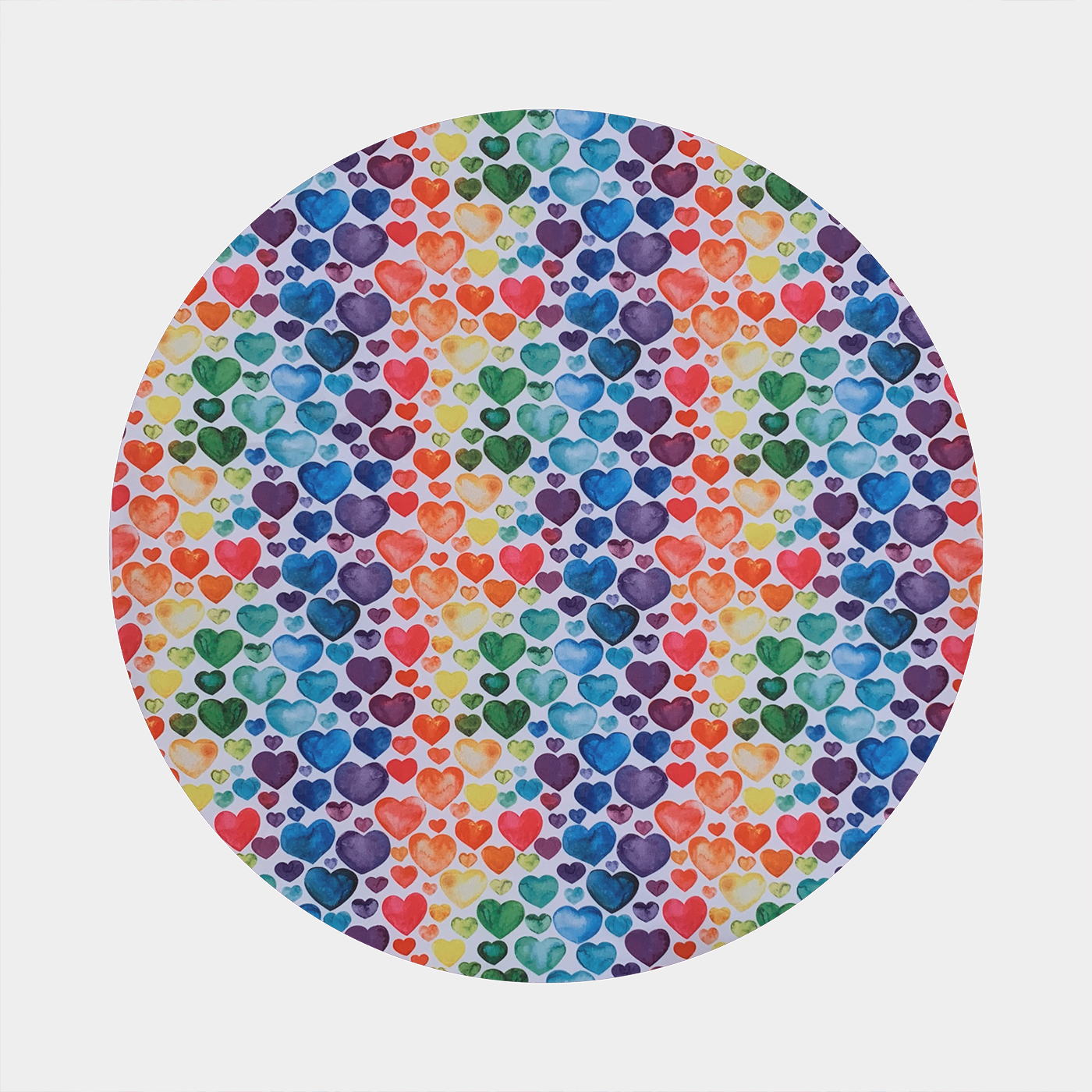 Pattern with white background and blue, purple, red, orange, yellow, and green hearts
